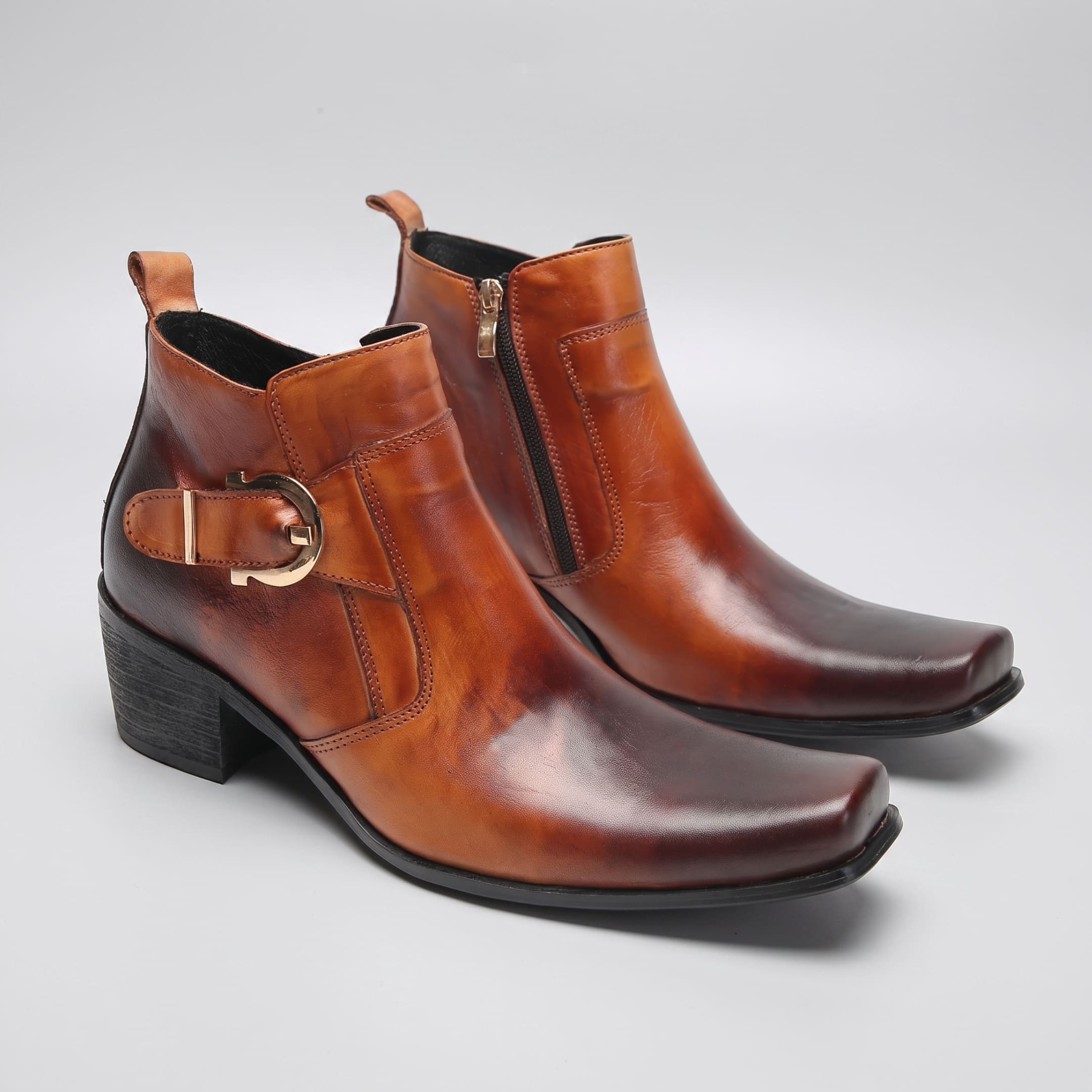 FORCIANO SCAROSSO brown genuine leather height increasing boot shown as a pair from the front three-quarter angle with buckle and zipper details.