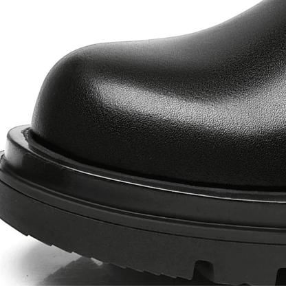 Close-up of the premium leather upper at the toe and sole edge of a FORCIANO SENTINEL black elevator Chelsea boot.
