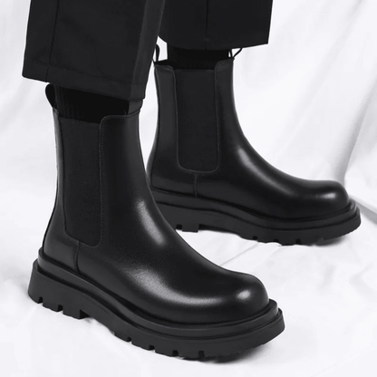 FORCIANO SENTINEL black elevator-chelsea-boot worn as a pair, showing elastic side panels, premium leather uppers, and lugged soles.