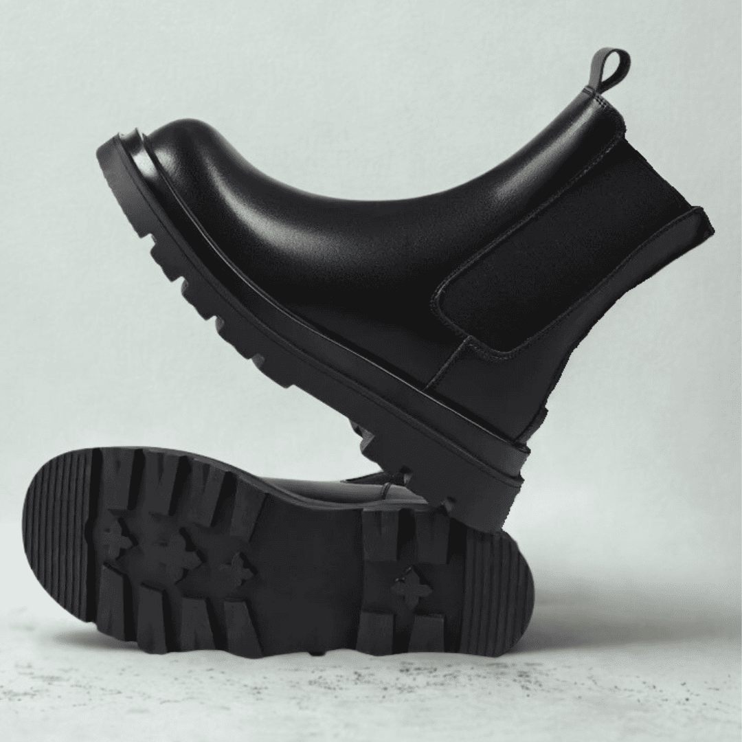 FORCIANO SENTINEL black elevator Chelsea boots shown in side profile with one outsole facing forward, highlighting the tread and premium leather upper.