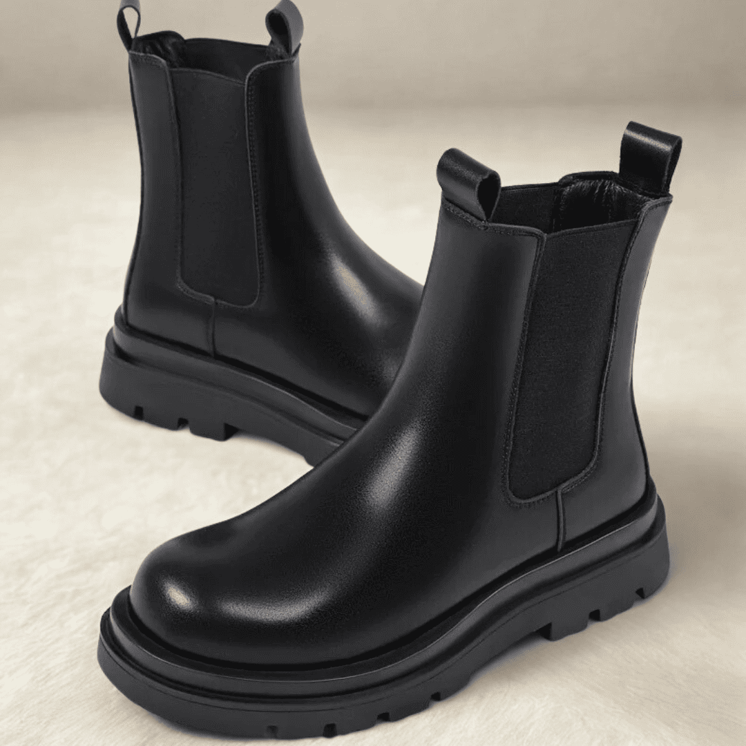 Pair of FORCIANO SENTINEL black elevator Chelsea boots in a front three-quarter product view, showing premium leather uppers and elastic side panels.