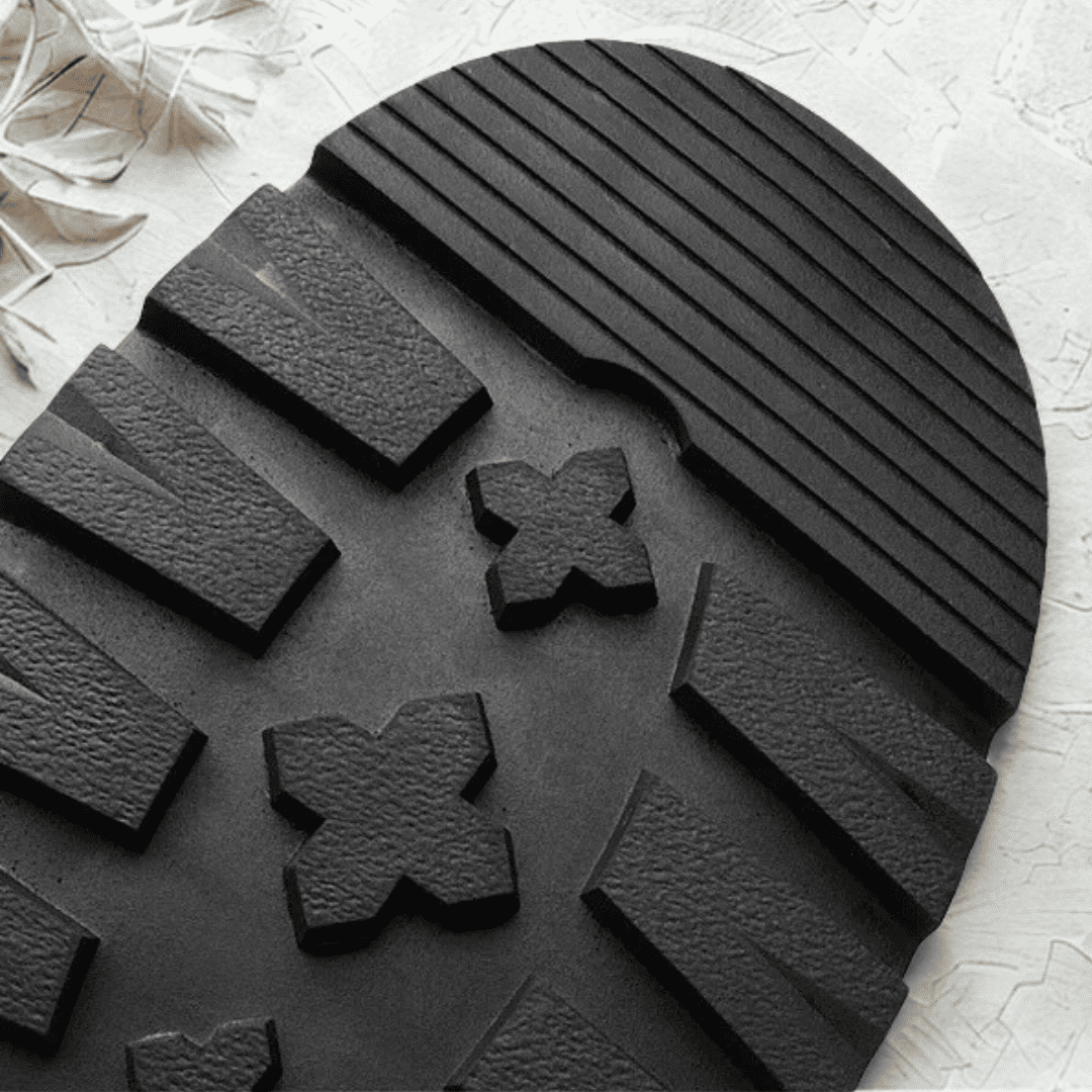 Close-up of the black lugged outsole on a FORCIANO SENTINEL elevator Chelsea boot, showing the textured tread blocks.