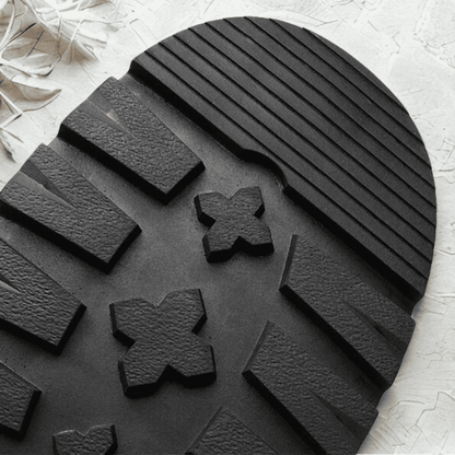 Close-up of the black lugged outsole on a FORCIANO SENTINEL elevator Chelsea boot, showing the textured tread blocks.