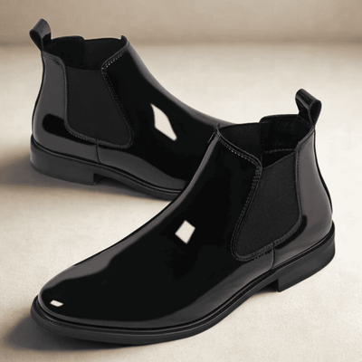 FORCIANO SILVAN black Chelsea Height Increasing Boots displayed as a pair from a front three-quarter angle, highlighting the glossy finish and elastic side panels.