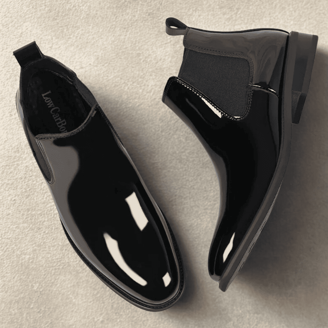 Pair of FORCIANO SILVAN black Chelsea Height Increasing Boots arranged from top and side angles, showing elastic panels, pull tabs and glossy finish.