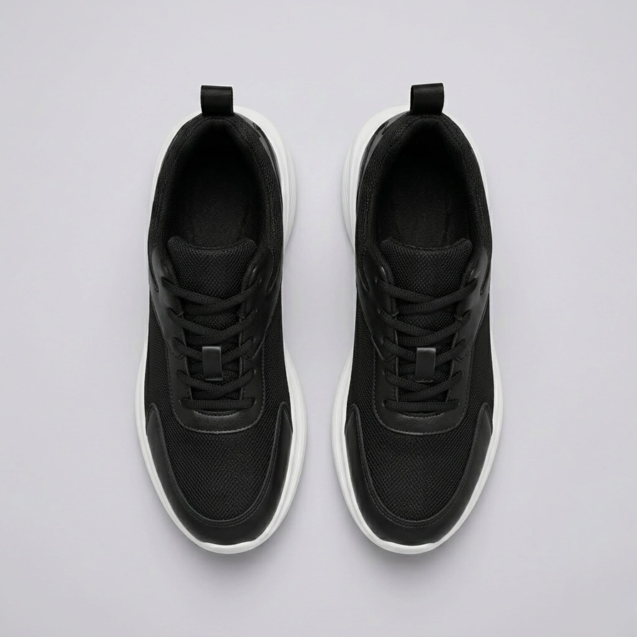 FORCIANO SUTTON black height increasing sneakers for women shown as a pair from above with laces, Flyknit mesh uppers and white sole edges.