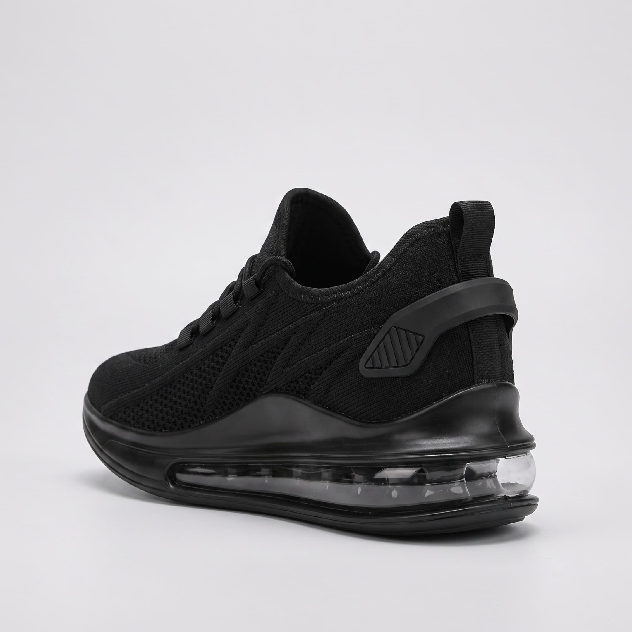 FORCIANO TENET black breathable air mesh height increasing sneakers shown from a rear three-quarter angle with the transparent heel sole section visible.