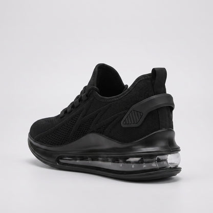 FORCIANO TENET black breathable air mesh height increasing sneakers shown from a rear three-quarter angle with the transparent heel sole section visible.