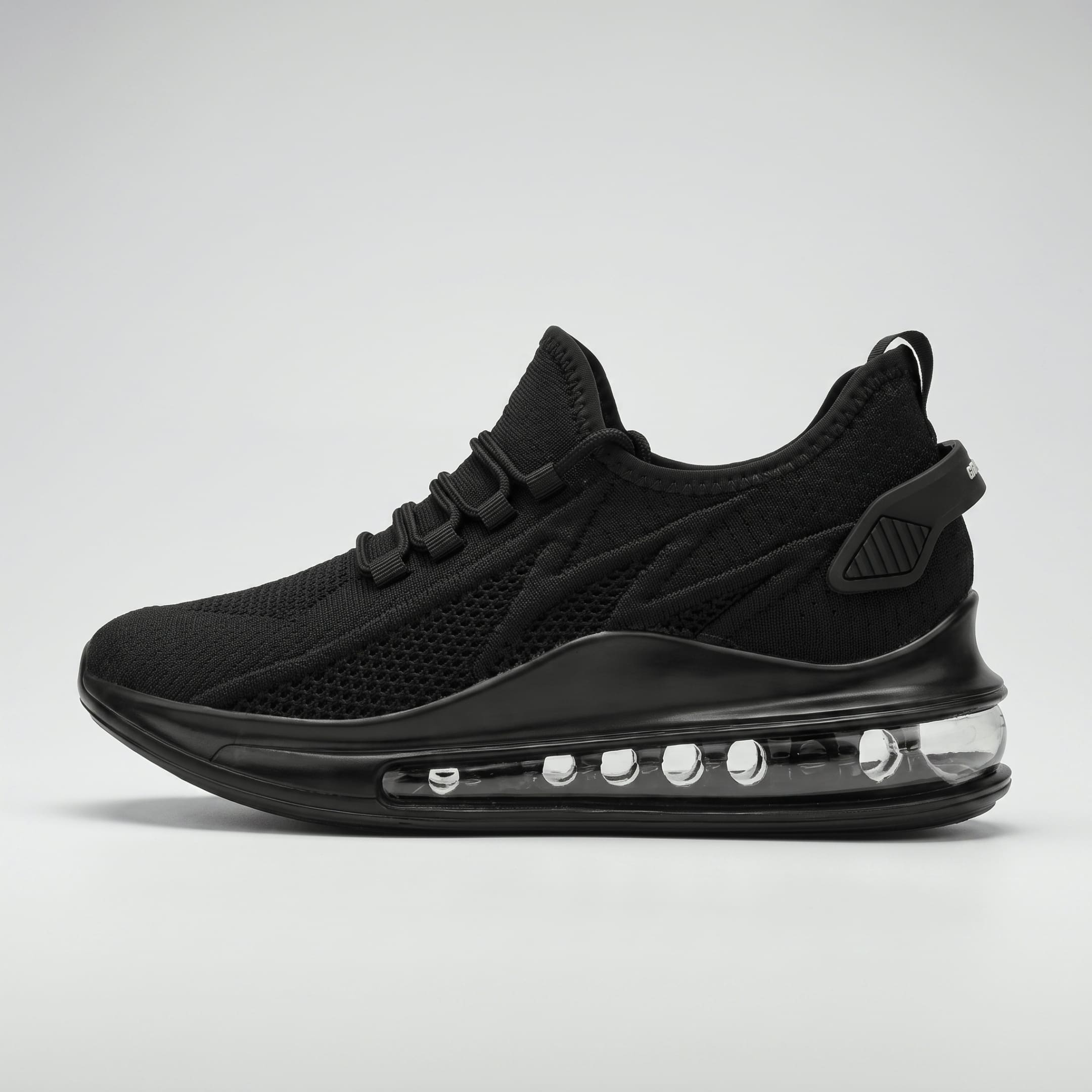 FORCIANO TENET black height increasing sneaker with breathable air mesh upper, shown from the side with transparent heel sole detail.