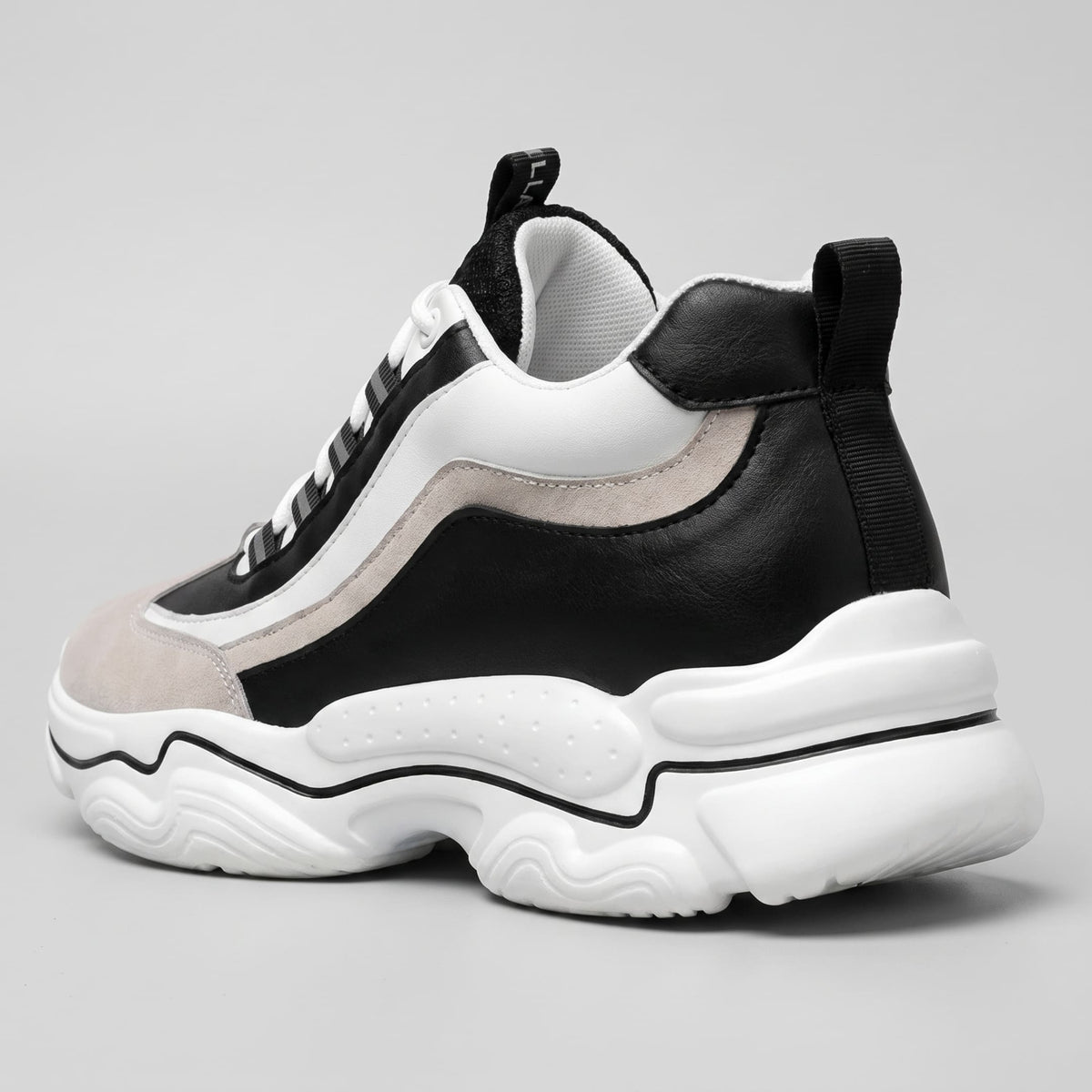 FORCIANO VALENCIA Height Increasing Sneakers for Women in black and white, shown from a rear three-quarter angle with the sculpted sole visible.